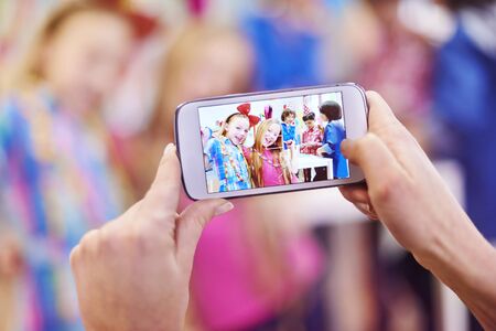 Mom taking a photo of her girlsの写真素材
