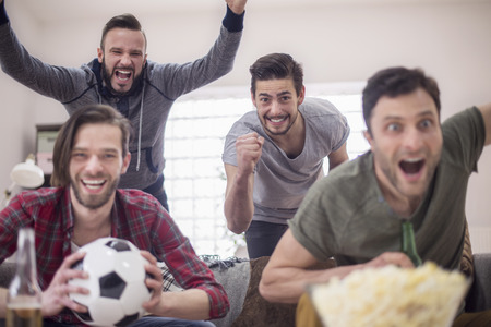Group of men support the favorite football teamの写真素材