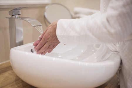 Washing hands in the bathroomの写真素材