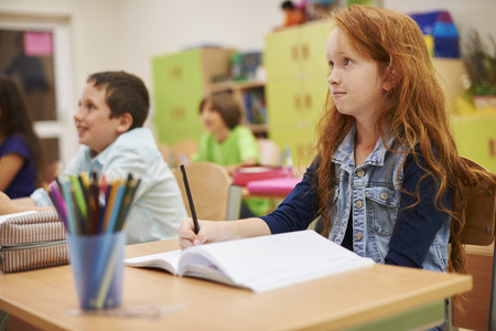 Students sitting at her desk during the lesson,の写真素材