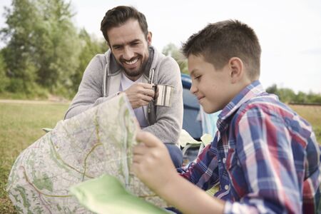 Boy planning a trail for him and his fatherの写真素材