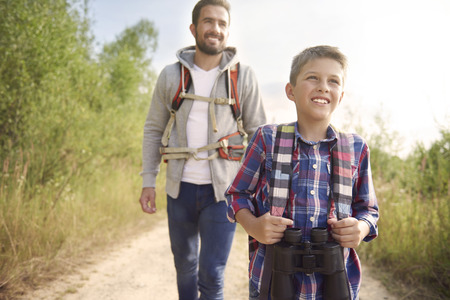 Curious boy hiking with his fatherの写真素材
