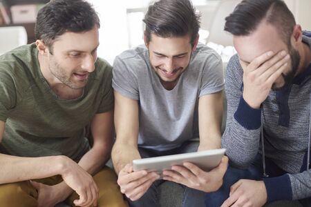 Friends browsing photos from their old timesの写真素材