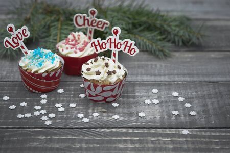 Delicious christmas muffins on wooden planksの写真素材