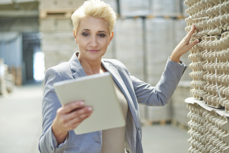 Female manager checking the merchandiseの写真素材