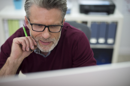 Close up of a man working on the computerの写真素材