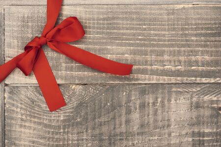 Red ribbon on the wooden planksの写真素材