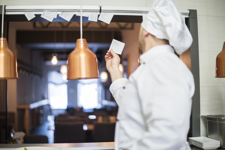 Rear view of chef taking ordersの写真素材