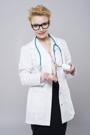 Doctor with a handful of pillsの写真素材