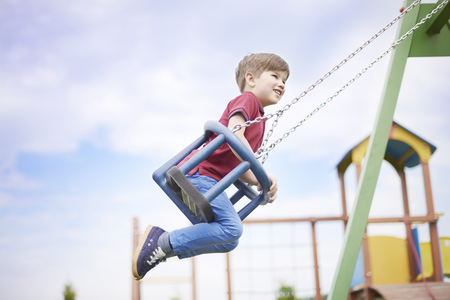 Little boy enjoying the time on the playgroundの写真素材