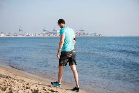 Tired man after jogging on the beachの写真素材