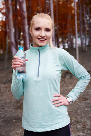 Woman holding a bottle of waterの写真素材