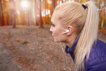 Breathing deep during jogging in the forestの写真素材