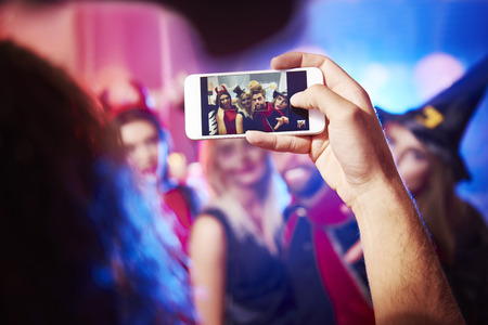Man taking photo of his friendsの写真素材
