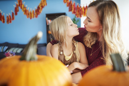 Small kiss from mum for her daughterの写真素材