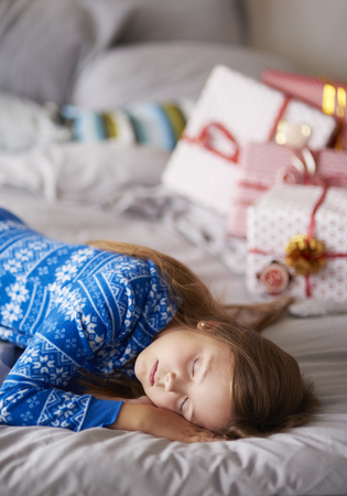 Sleeping girl in Christmas morningの写真素材