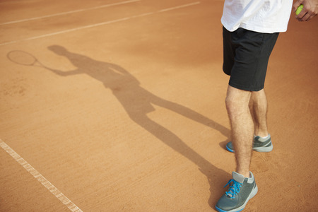 Shadow of the man who's playing the tennisの写真素材