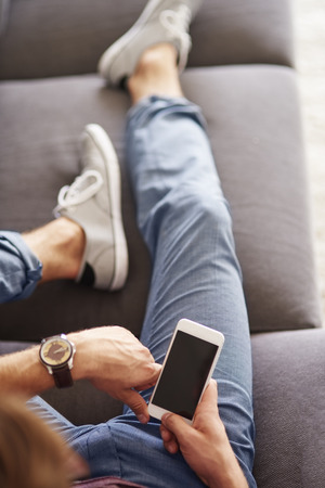 Close up man which holding the mobile phoneの写真素材