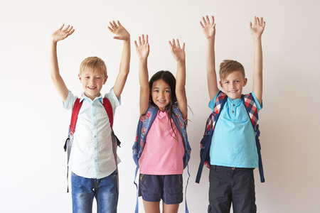 Children on white bakcground with hands upの写真素材