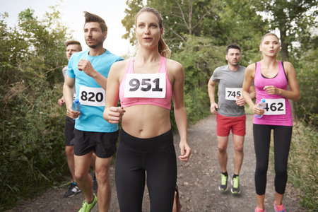 Team of jogging people in the forest