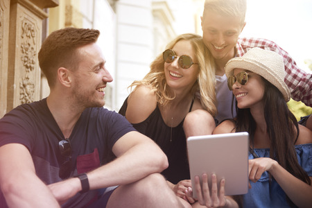 Group of friends with digital tablet in summer day の写真素材