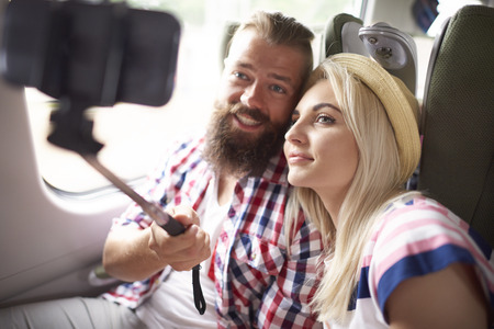 Couple taking selfie in the train の写真素材