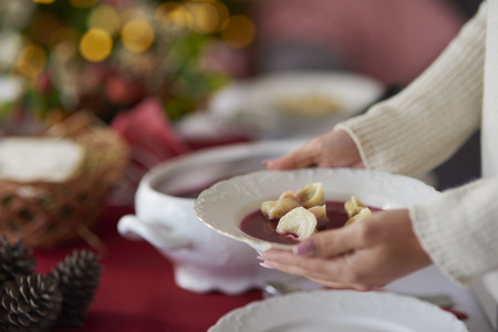 Woman holding a plate with beetroot soupの写真素材