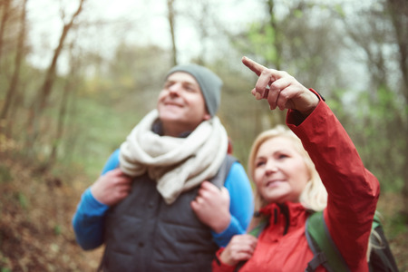 Woman pointing at something in the airの写真素材