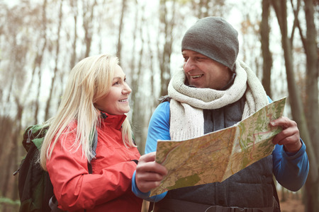 Couple using paper map while hiking