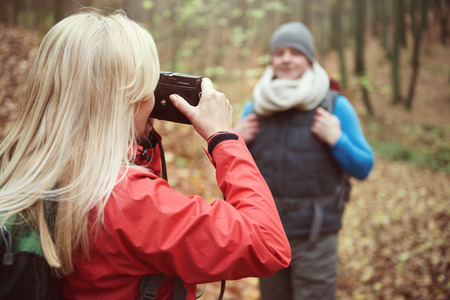 Woman taking picture of her husbandの写真素材