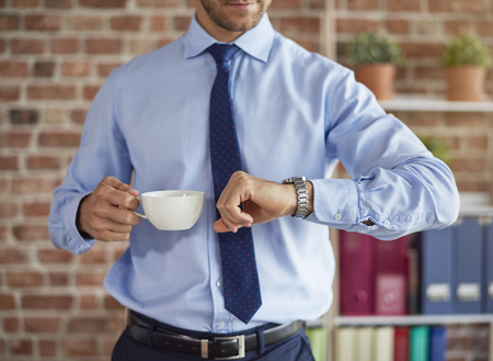 Man checking time on his watchの写真素材