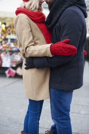 Couple hugging on the christmas marketの写真素材