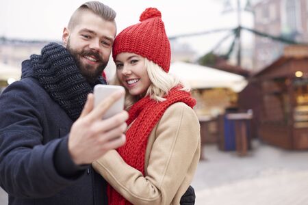 Taking selfie next to the christmas marketの写真素材