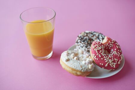 Picture of glass with juice and donuts