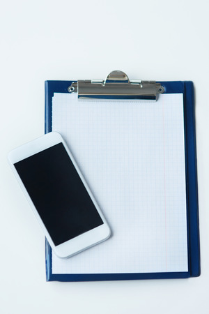 Clipboard and smartphone directly aboveの写真素材