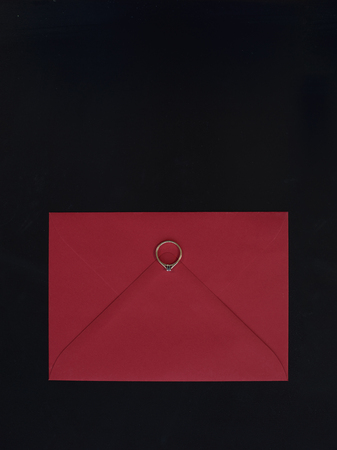 Engagement ring on red envelope