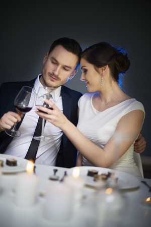 Couple toasting with wine during dinner timeの写真素材