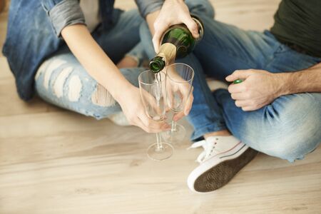Couple cheering new life with glass of champagneの写真素材