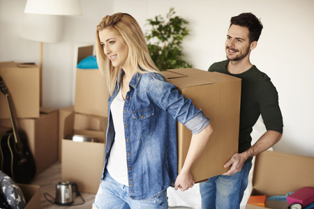 Couple unpacking boxes in their new home 