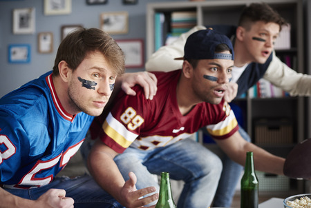 Front view of excited men watching sports game