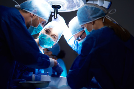 Busy surgeons over the operating table
