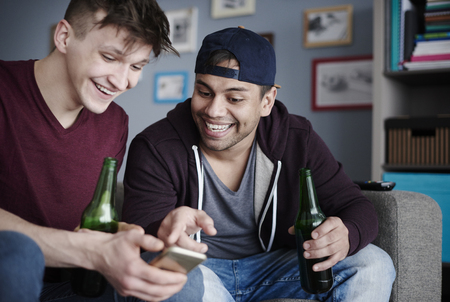 Best mates with cell phone and drinksの写真素材