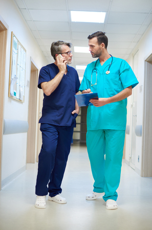 Two busy doctors on the corridorの写真素材