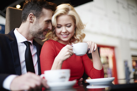 Side view of embraced couple in cafeの写真素材