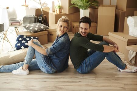 Side view of couple sitting back to back