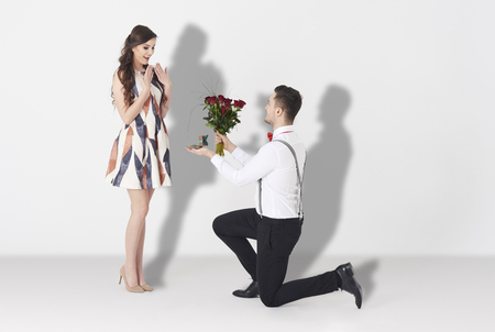 Young man surprising woman with engagementの写真素材