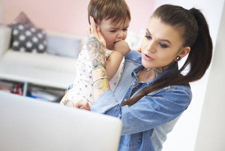Mother trying to calm her toddler sonの写真素材