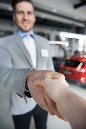 Close up of handshake in the showroomの写真素材