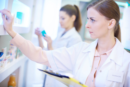 Close up of pharmacist doing stocktakeの写真素材