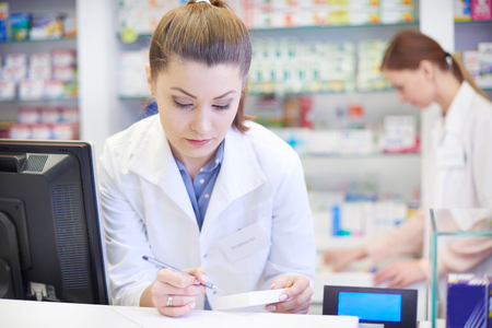Female pharmacist working in drugstoreの写真素材